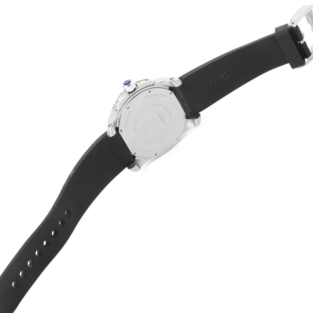 This image shows the back case and black rubber strap of a Calibre de Cartier model by Cartier, viewed from behind.