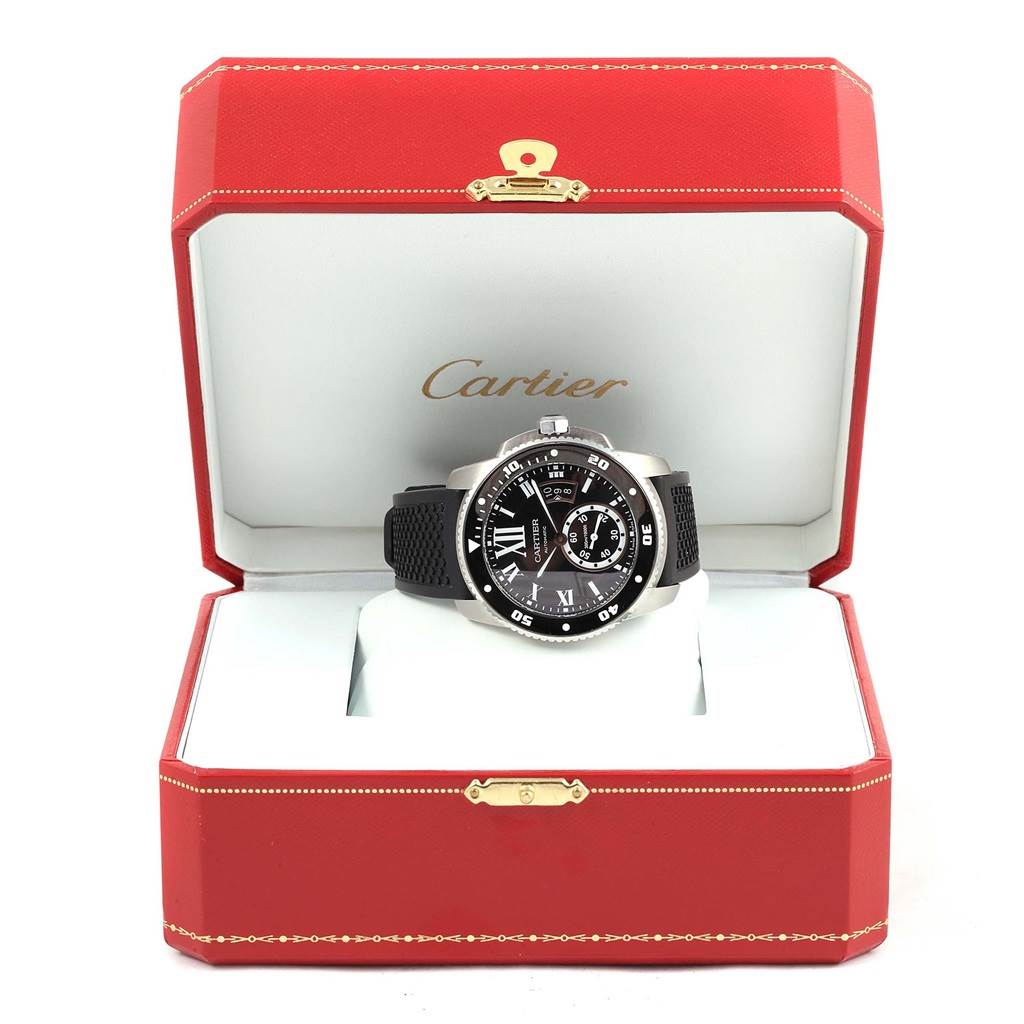 The Calibre de Cartier watch by Cartier is displayed front-facing in an open red Cartier box.
