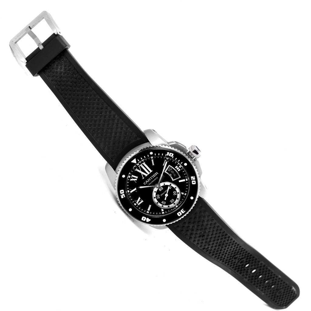 The Calibre de Cartier watch by Cartier is shown at an angle displaying the face, bezel, crown, and rubber strap.