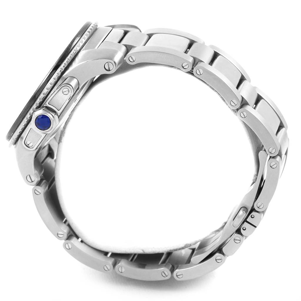 This side view of the Calibre de Cartier watch by Cartier shows its stainless steel bracelet and crown with a blue sapphire cabochon.