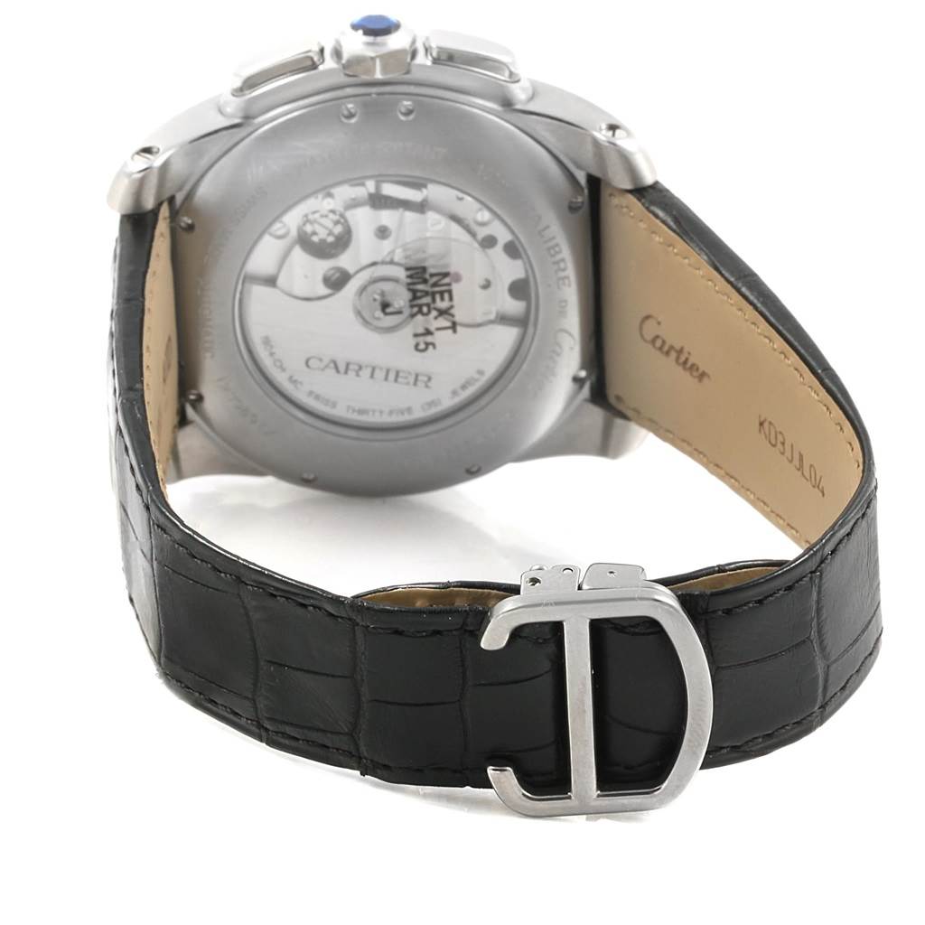 The image shows the backside of the Calibre de Cartier watch by Cartier, highlighting the movement and black leather strap.