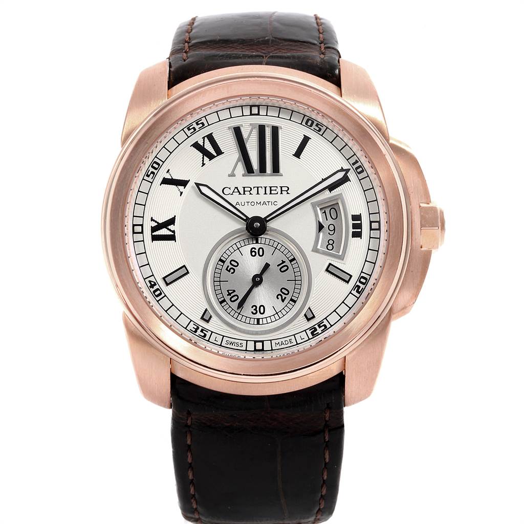 This image shows a straight-on view of the Calibre de Cartier watch by Cartier, featuring its dial, case, and strap.