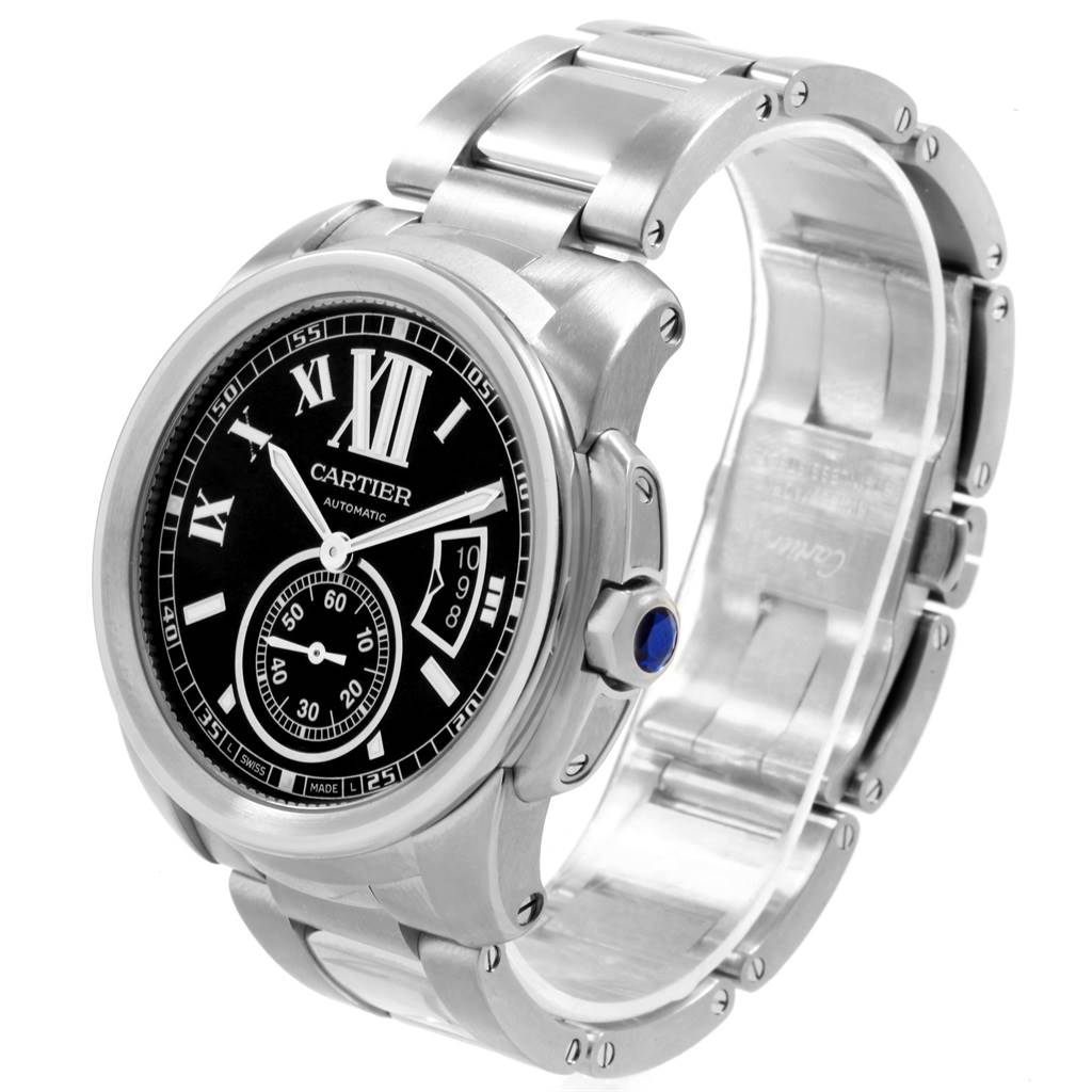 The image shows a Calibre de Cartier watch by Cartier from a slight front angle, displaying the face, crown, and part of the bracelet.