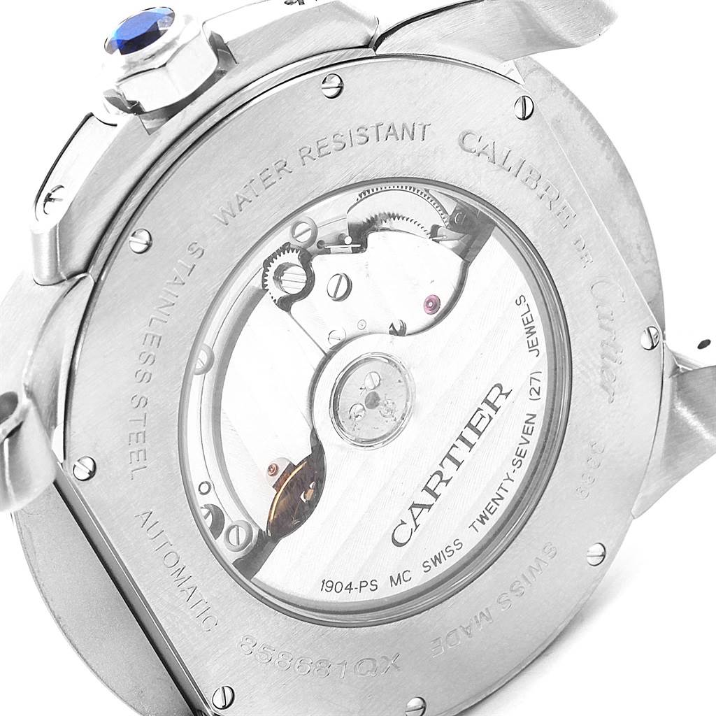 The image shows the back view of the Calibre de Cartier watch by Cartier, displaying its automatic movement and markings.