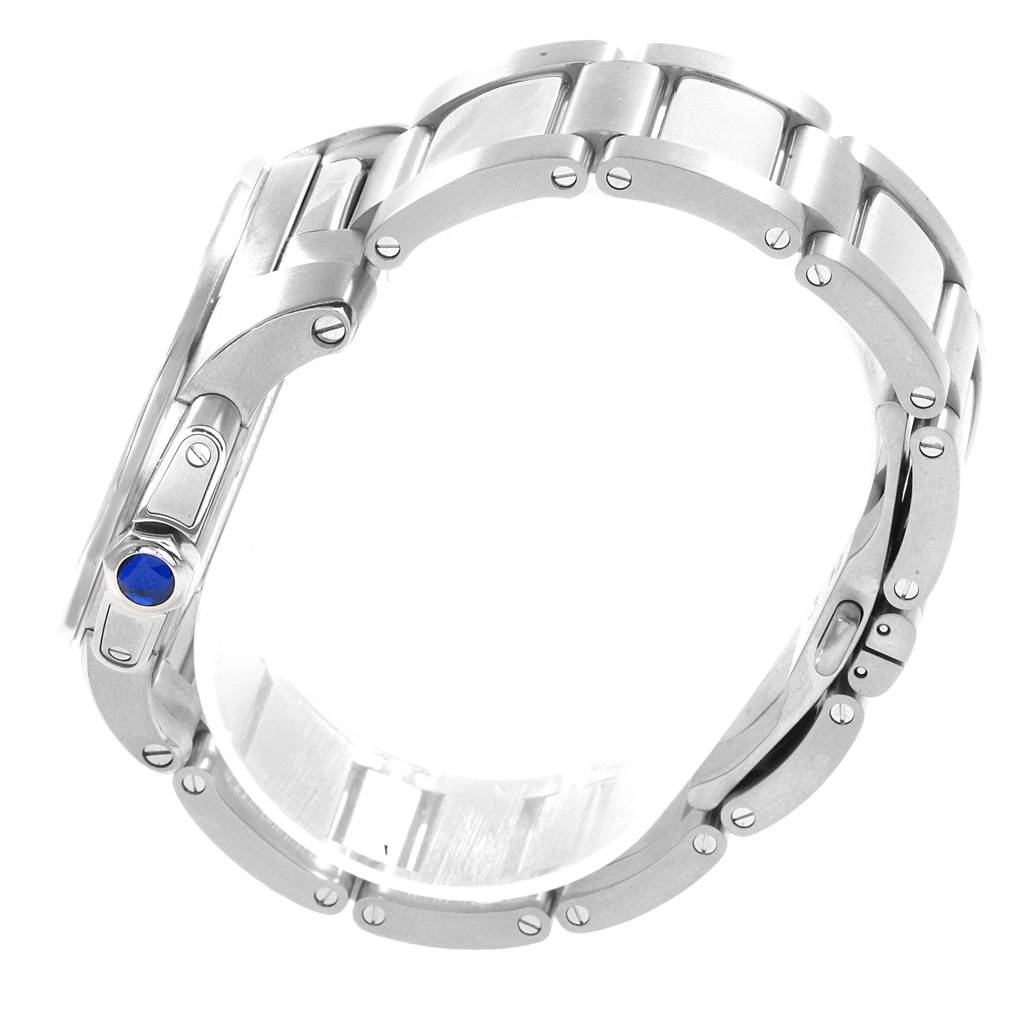 The image shows the bracelet and side profile of a Calibre de Cartier watch by Cartier, with a focus on the band links and crown with a blue gemstone.
