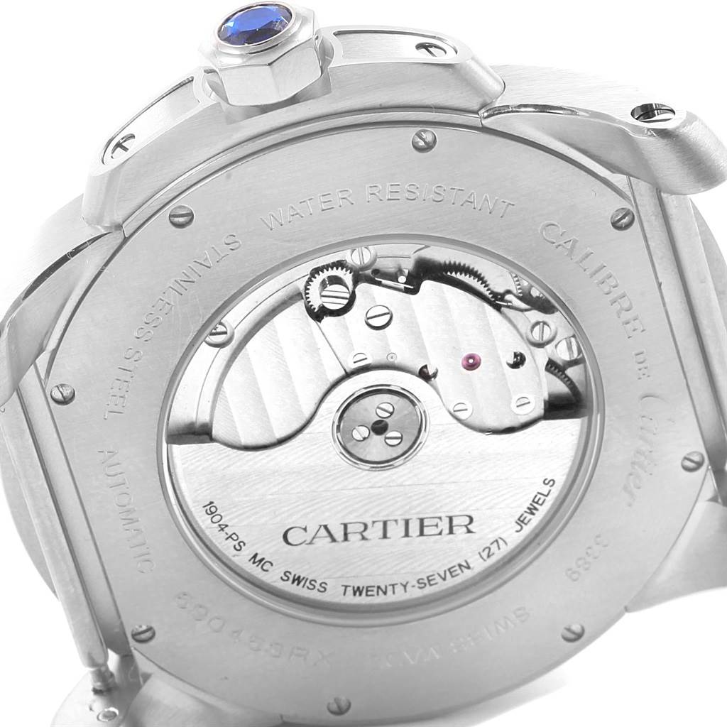 The image shows the back side of a Calibre de Cartier watch by Cartier, highlighting its automatic movement and inner workings.