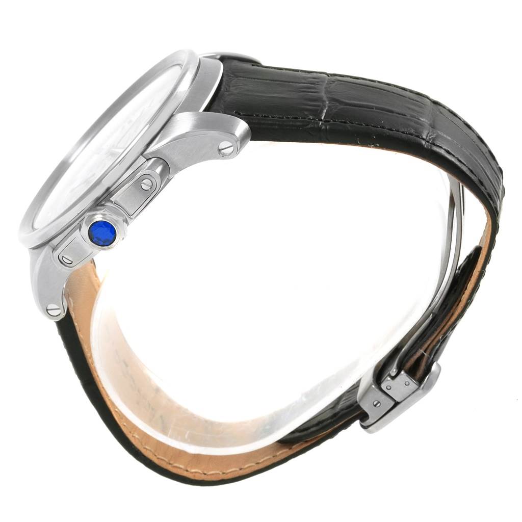 The image shows a side view of the Calibre de Cartier watch by Cartier, highlighting its crown, case, and leather strap.