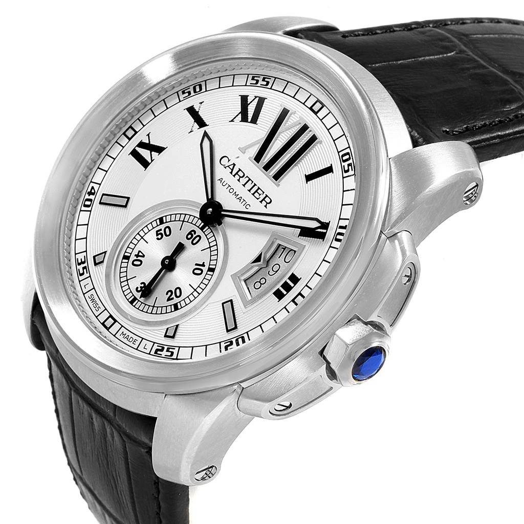 This is a close-up angled view of the Calibre de Cartier watch by Cartier, showing its face, dial, case, strap, and crown.