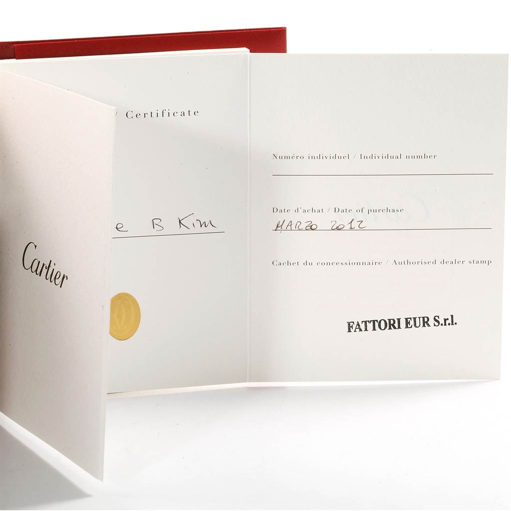 The image shows the warranty booklet and certificate for a Calibre de Cartier watch by Cartier.