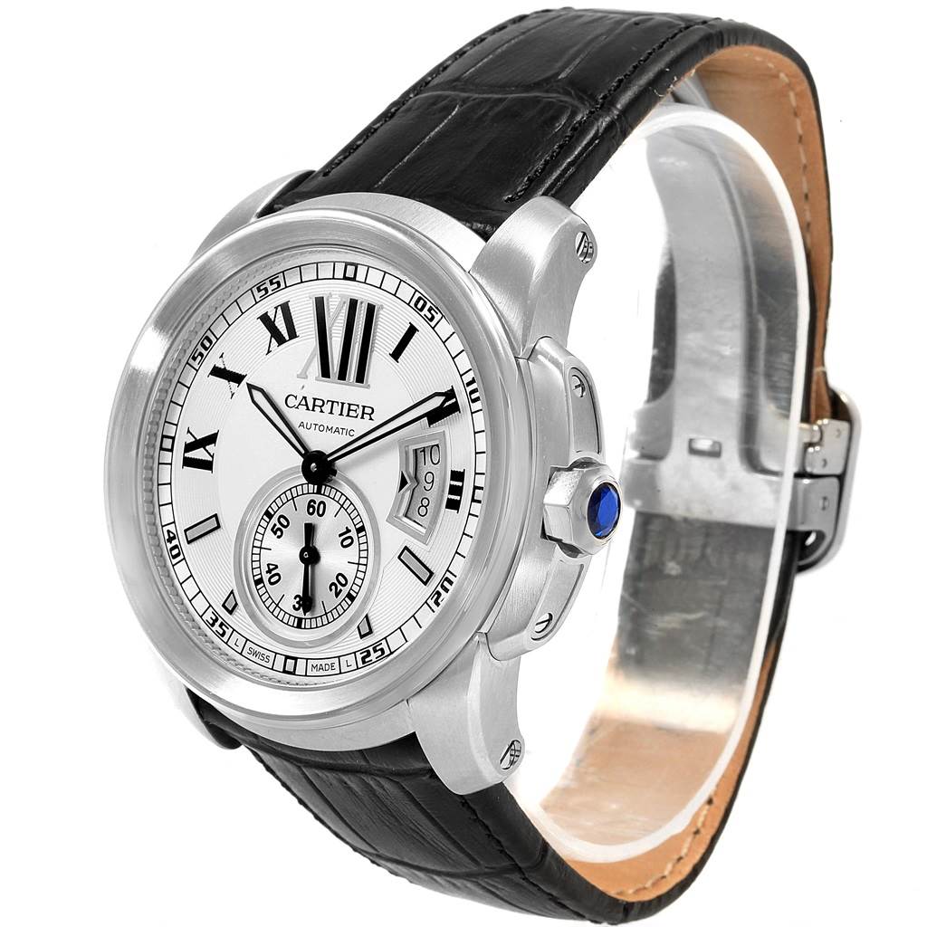 The image displays a Calibre de Cartier watch by Cartier at a three-quarter angle, showing the face, strap, and crown.