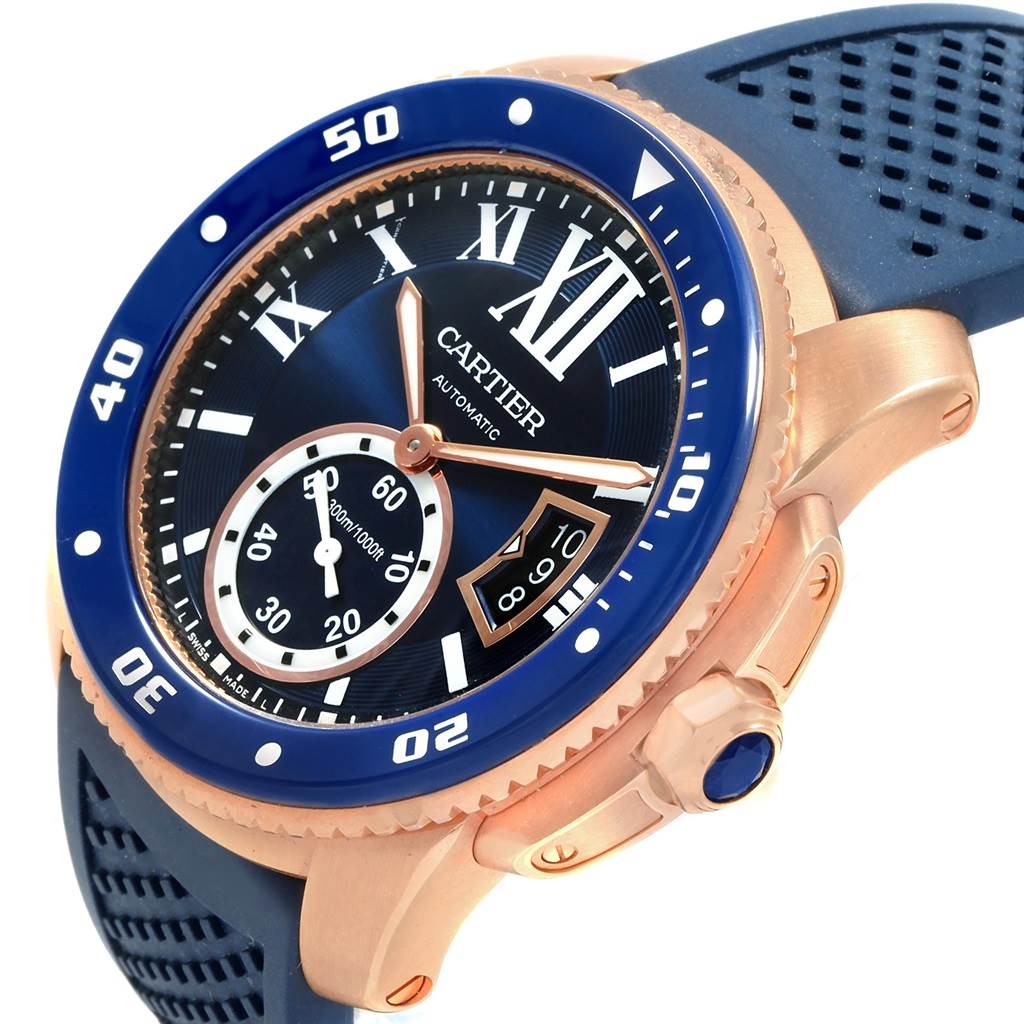 This image shows a close-up, angled view of the face, bezel, crown, and part of the strap of a Calibre de Cartier watch by Cartier.