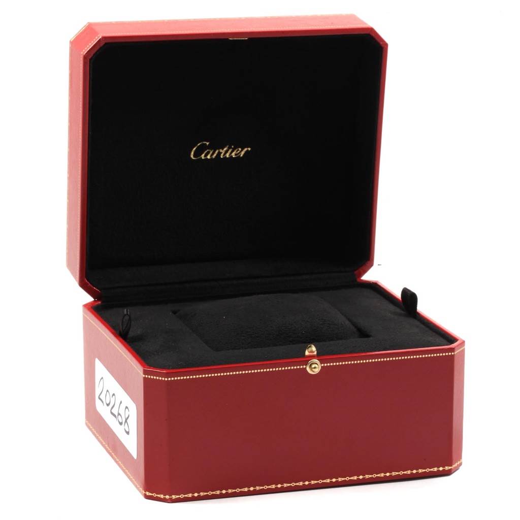 The image shows an open red Cartier box for the Calibre de Cartier model, displaying the inner cushion and branding.