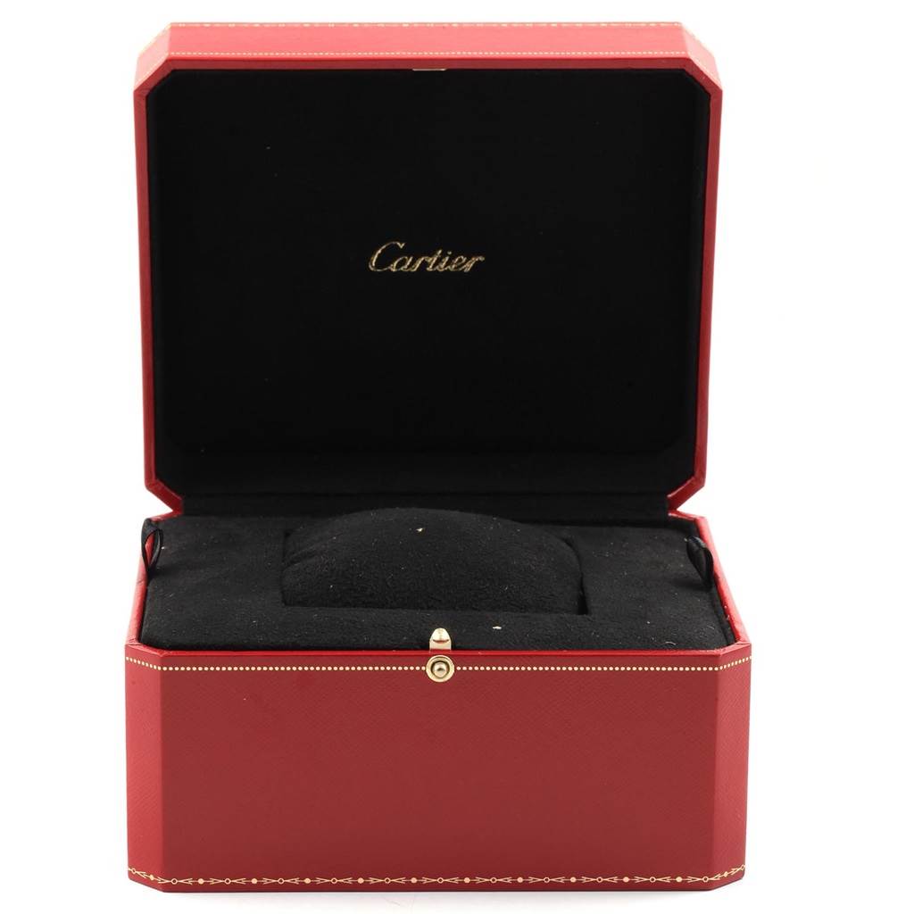 This image shows an open red box for a Calibre de Cartier watch by Cartier, displaying the cushioned interior.