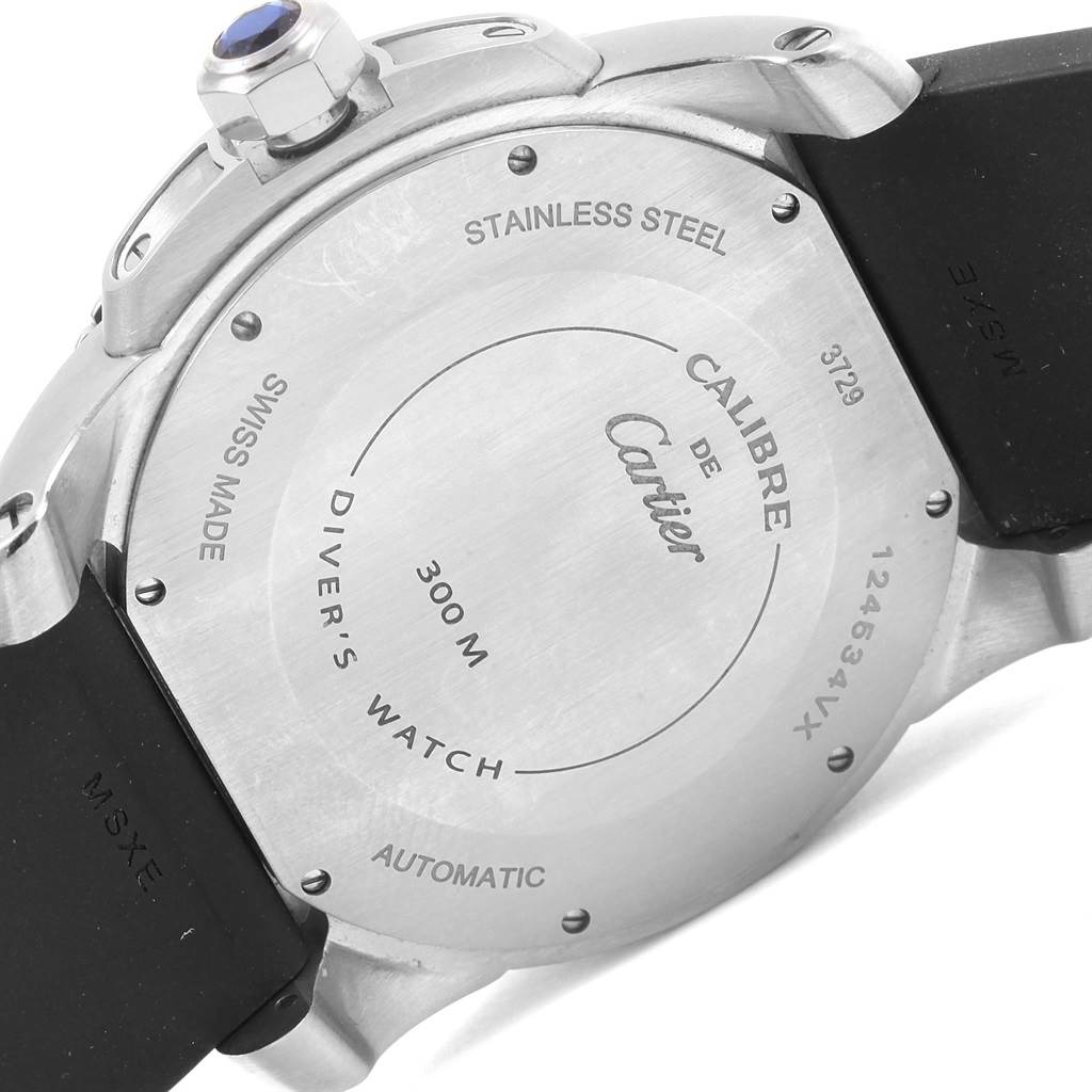 The image shows the back case of the Calibre de Cartier diver's watch by Cartier, featuring engravings and a stainless steel finish.