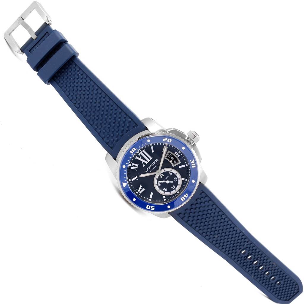 The image shows the front-facing angle of a Calibre de Cartier watch by Cartier with a blue strap and bezel.