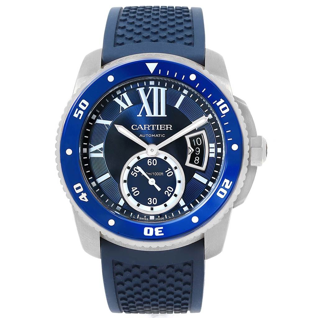 The Calibre de Cartier watch by Cartier is shown from a front angle, highlighting its blue dial, bezel, and rubber strap.