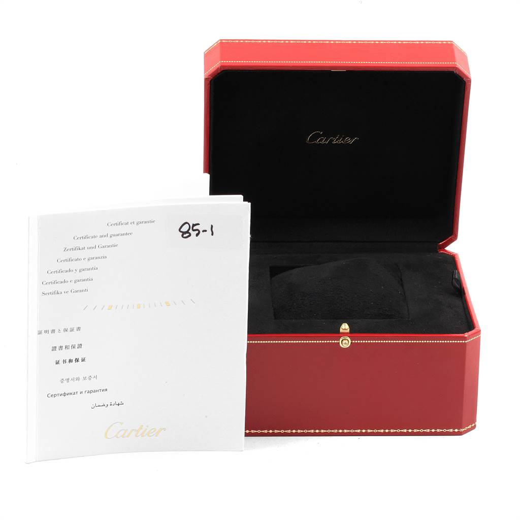The image shows an open red Cartier watch box and warranty booklet for the Calibre de Cartier model by Cartier.