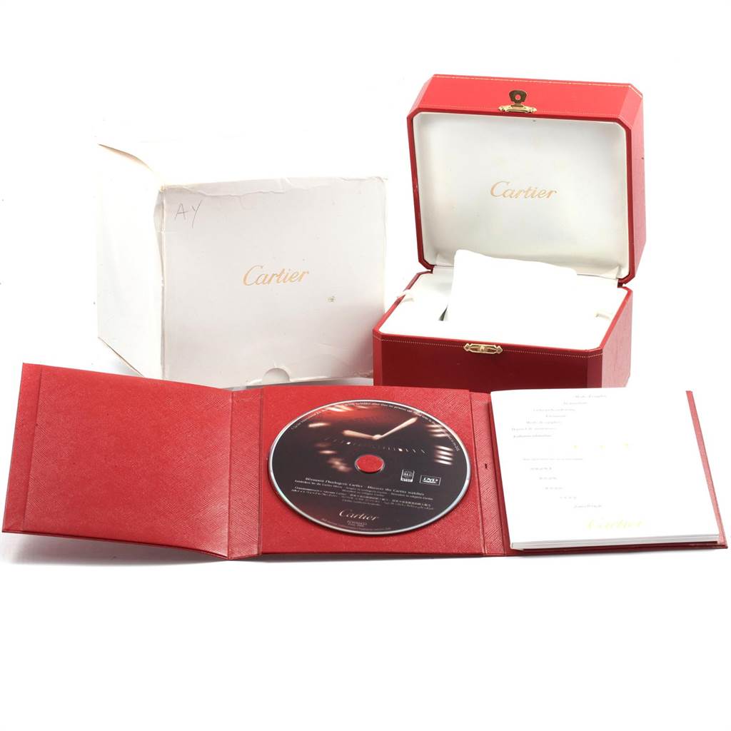 This image shows the packaging and accessories for a Calibre de Cartier watch by Cartier, including the box, pouch, and documentation.