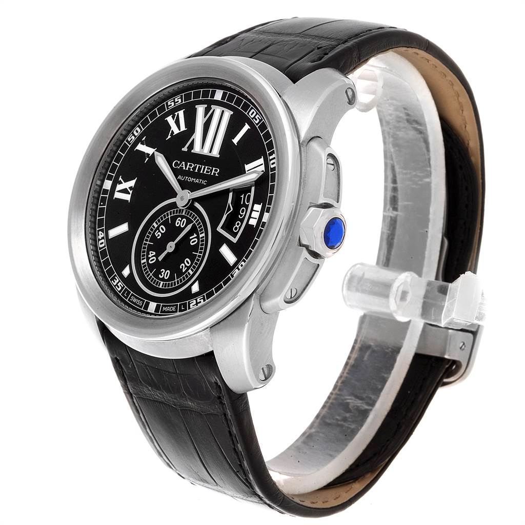 The Calibre de Cartier model by Cartier is shown at a three-quarter angle, highlighting its black dial, Roman numerals, and leather strap.