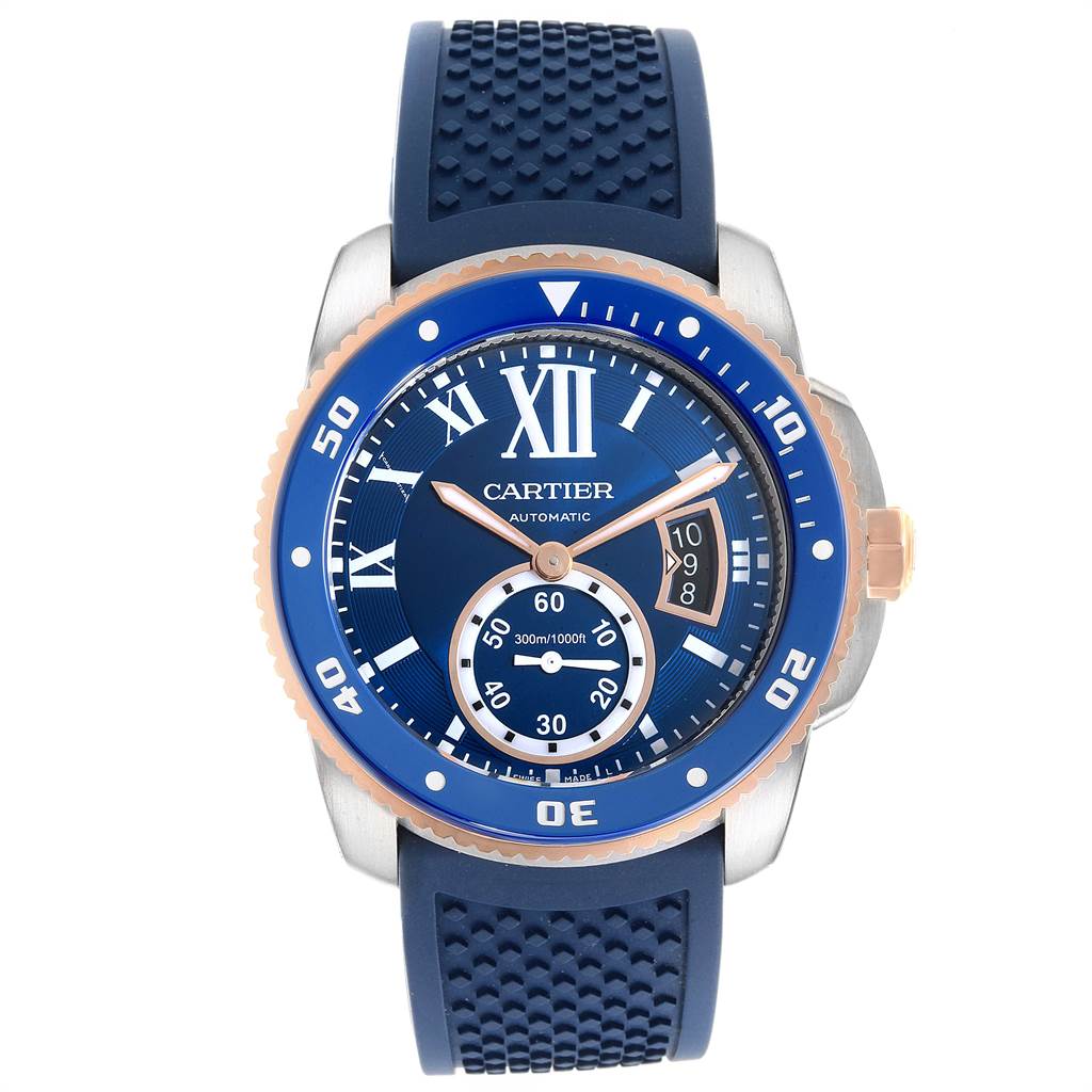 The image shows a front-view angle of the Calibre de Cartier watch by Cartier, highlighting its blue dial and rubber strap.