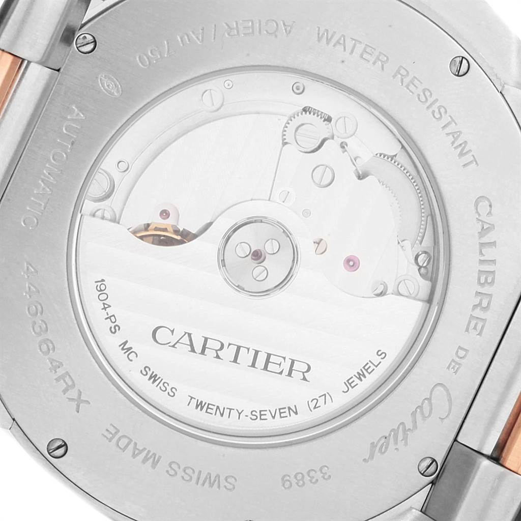 The image shows the back view of a Calibre de Cartier watch by Cartier, highlighting its automatic movement mechanism.