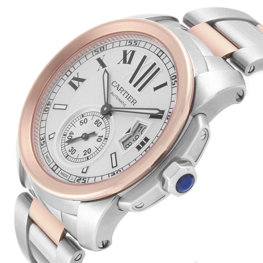 The image shows an angled view of the Calibre de Cartier watch displaying the face, crown, and partial bracelet band.