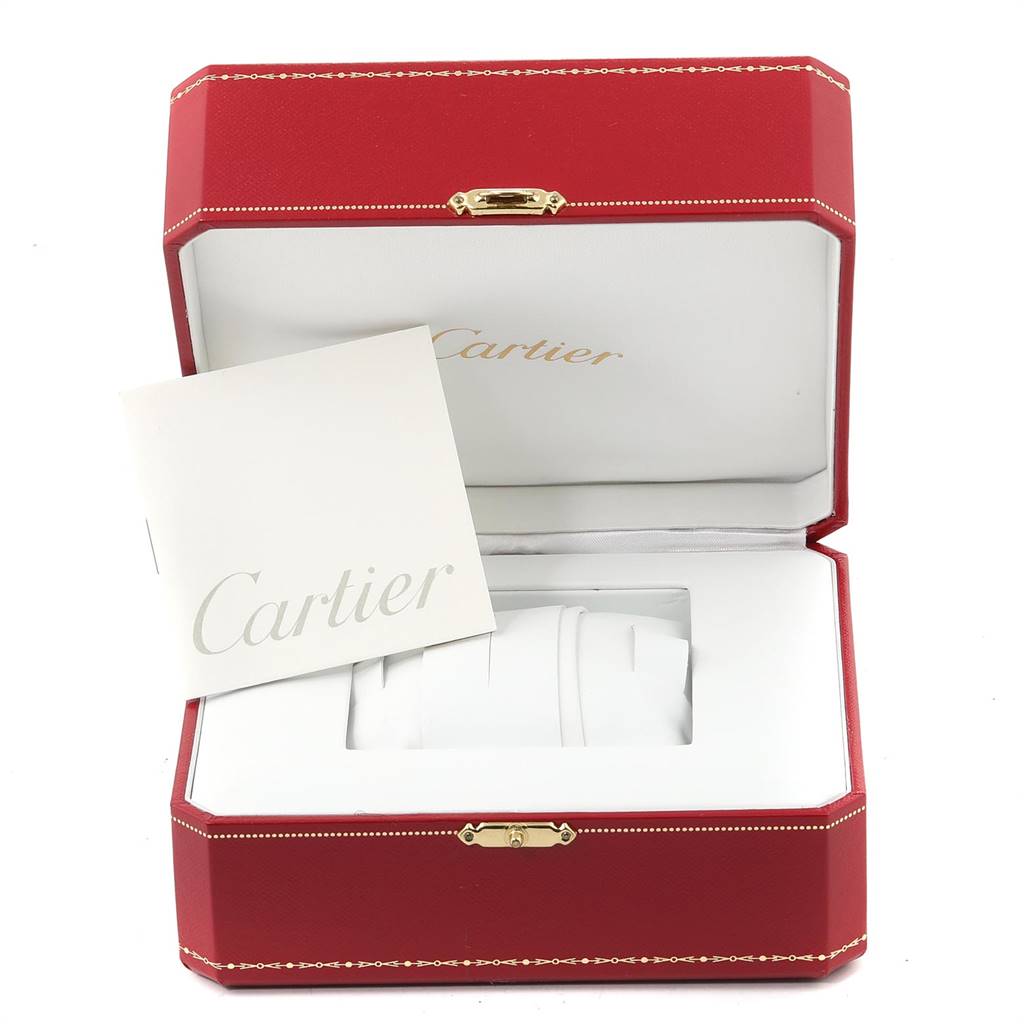The image shows an open Cartier box for the Calibre de Cartier model, featuring a manual and a watch holder.