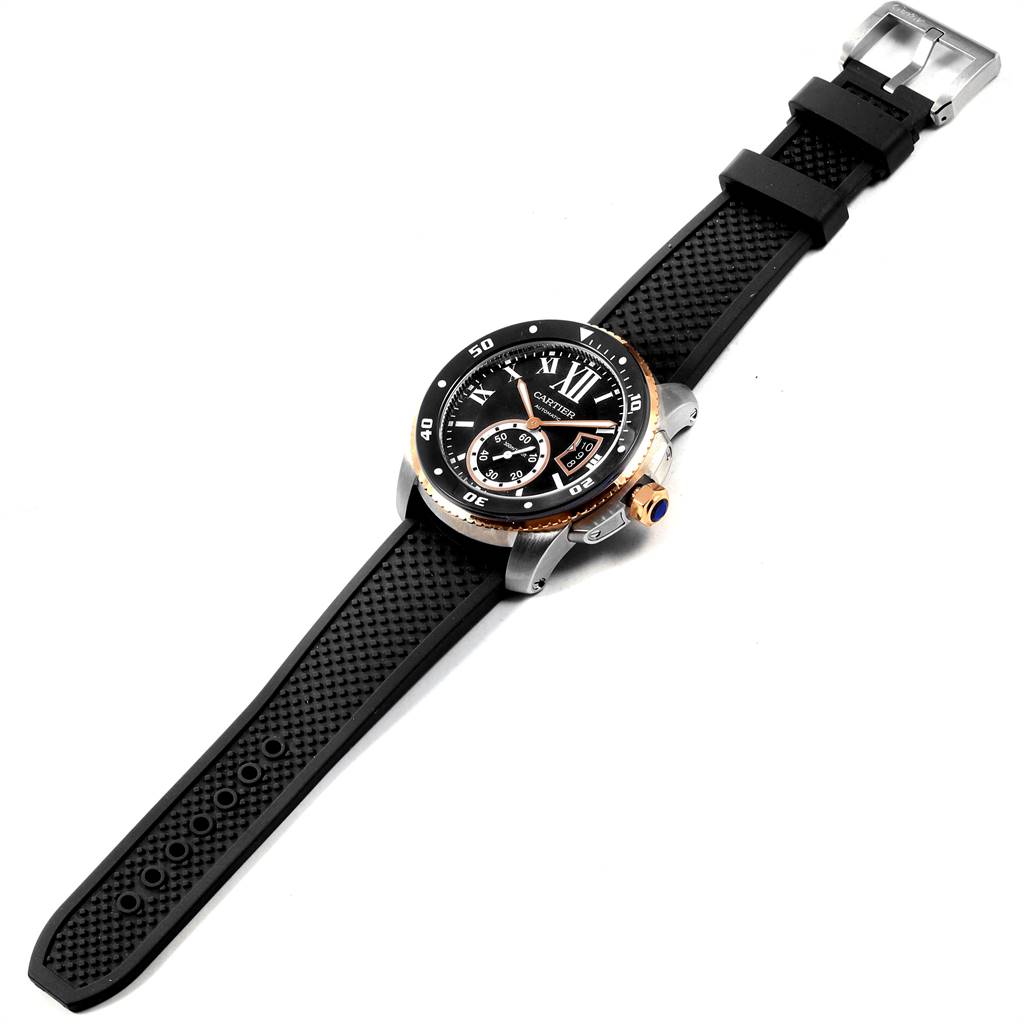 The Calibre de Cartier watch by Cartier is shown at a slightly elevated angle displaying its face, strap, and buckle.