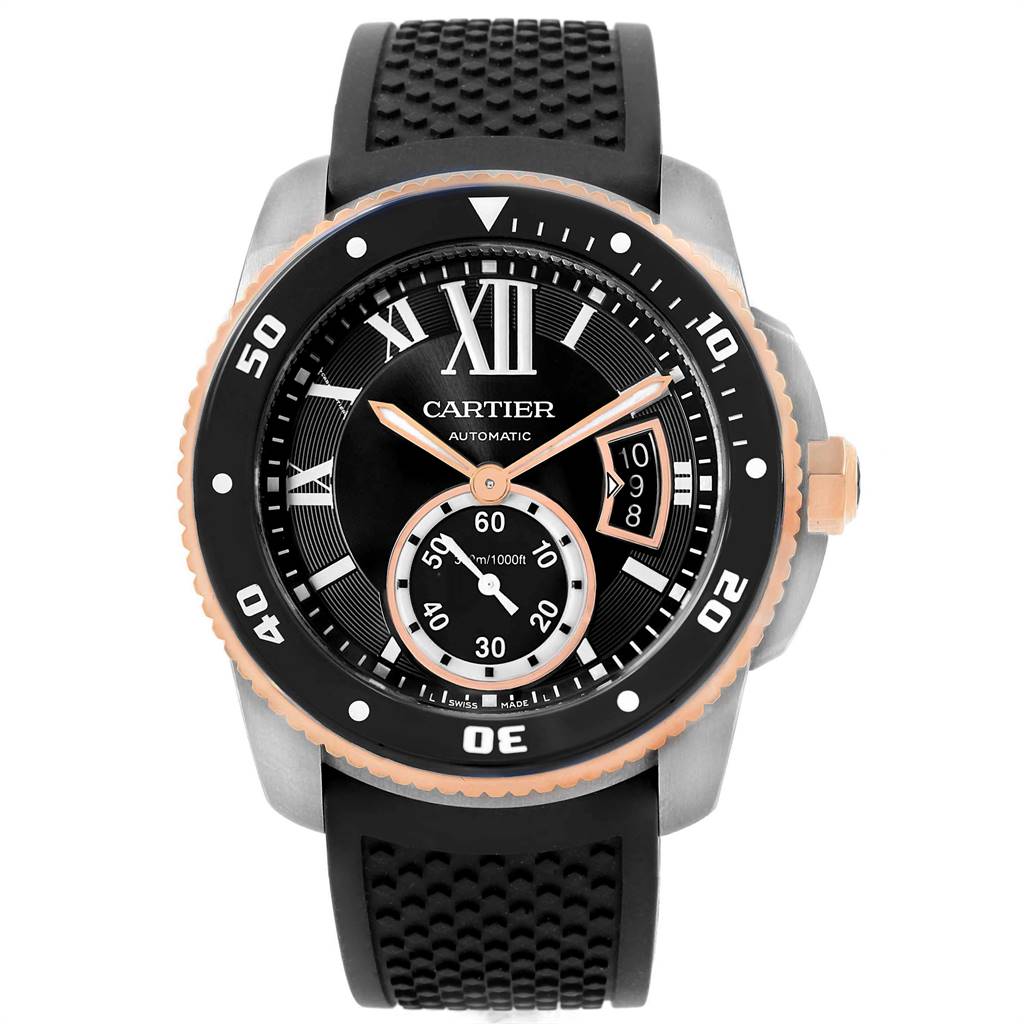 The image shows a front view of the Calibre de Cartier watch by Cartier, highlighting its dial, bezel, and black rubber strap.