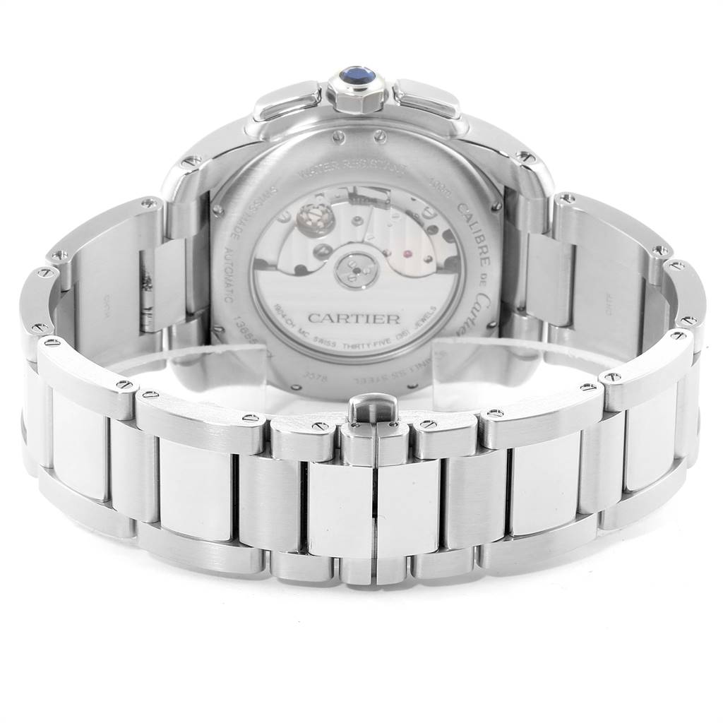 The image shows the back view of a Calibre de Cartier watch by Cartier, highlighting its open case back and bracelet.