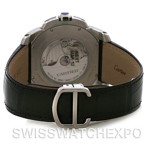 The image shows the back view of a Calibre de Cartier watch by Cartier, highlighting the movement through a transparent case back and the leather strap.