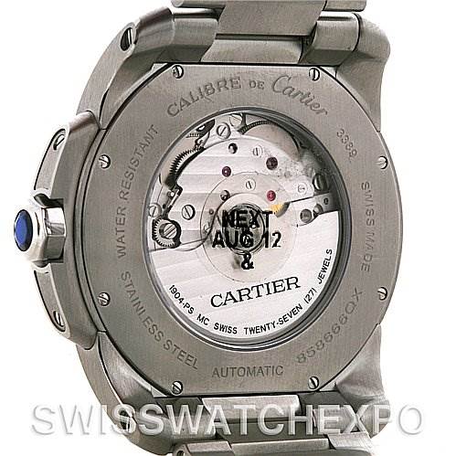 The image shows the back view of a Calibre de Cartier watch, highlighting the automatic movement and stainless steel case.