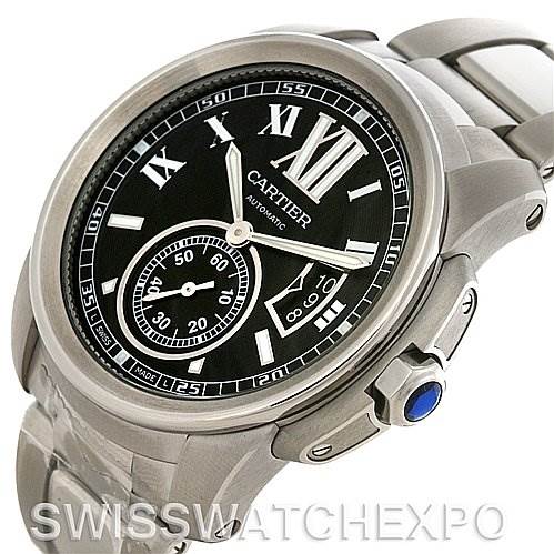 The image shows a close-up angle of the dial, crown, and part of the strap of the Calibre de Cartier watch by Cartier.