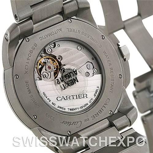 The image shows the back case and movement of the Calibre de Cartier model by Cartier, highlighting the automatic mechanism.