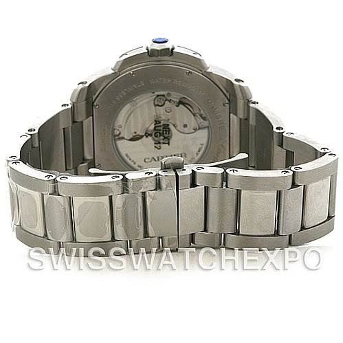 The image shows the back of a Calibre de Cartier watch by Cartier, including the case back and stainless steel bracelet.