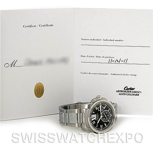 The image shows a Calibre de Cartier watch by Cartier with a certificate, viewed from a front angle displaying its face and part of the bracelet.