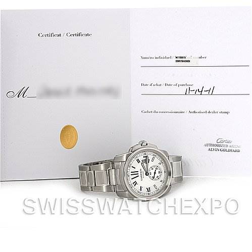 The image shows a Calibre de Cartier watch by Cartier and its certificate, viewed from the front.