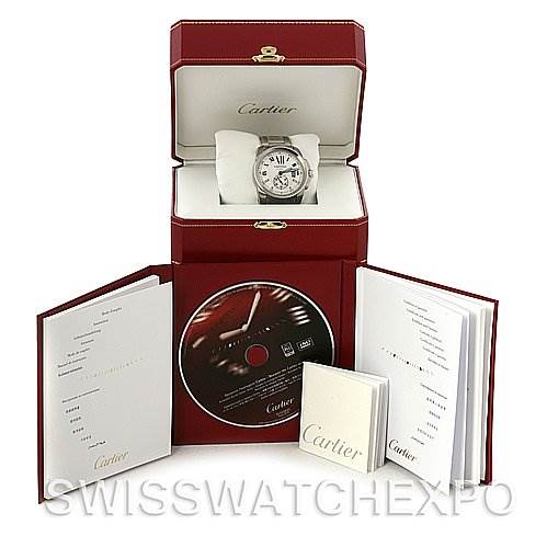 The image shows a Calibre de Cartier watch by Cartier in its opened box, along with manuals and a CD.