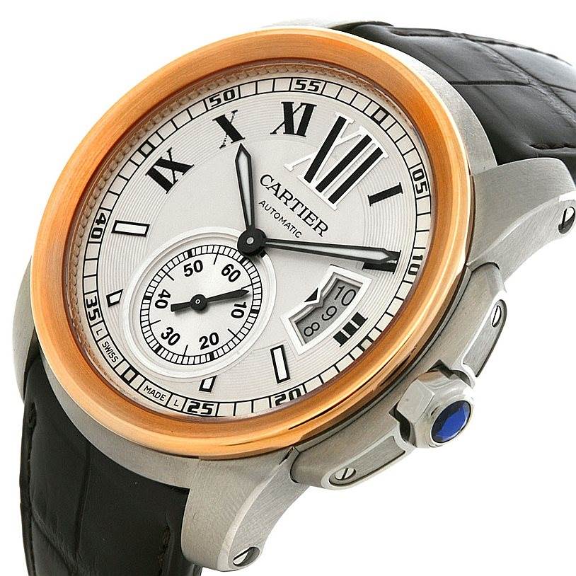 The image shows a Calibre de Cartier watch by Cartier at an angled view, highlighting its dial, crown, bezel, and leather strap.