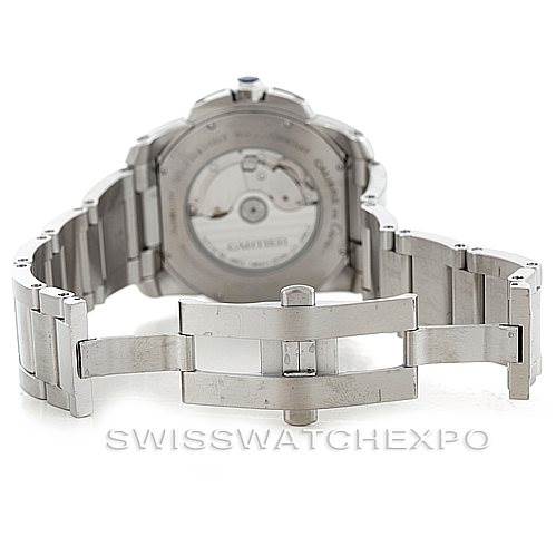 The image shows the back view of the Calibre de Cartier watch by Cartier, focusing on the open clasp and the visible movement mechanism.