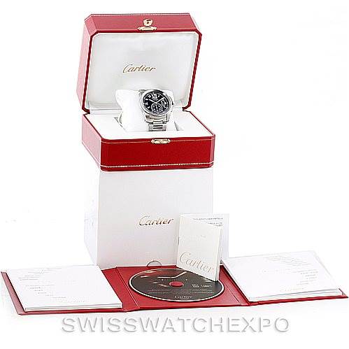 The Calibre de Cartier watch by Cartier is displayed in its box with manuals, a CD, and additional documentation surrounding it.