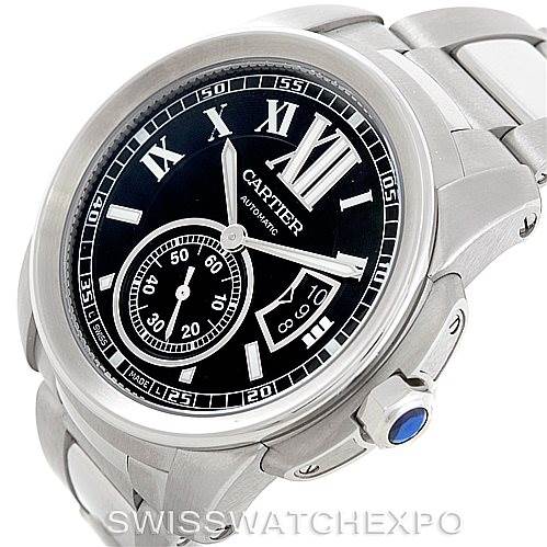 The image shows an angled view of a Calibre de Cartier watch by Cartier, highlighting its face, bezel, crown, and part of the bracelet.