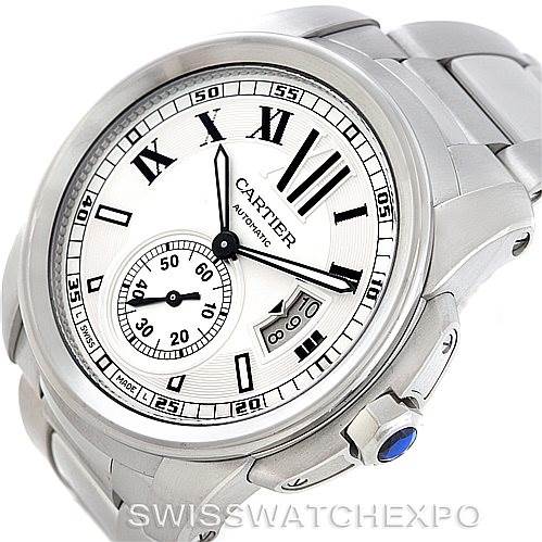 The image shows a Calibre de Cartier watch by Cartier at an angled view, highlighting its dial, crown, and bracelet.