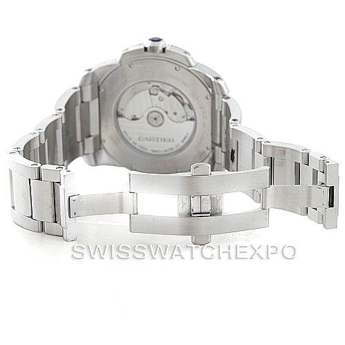 The image shows the back and opened clasp of the Calibre de Cartier model by Cartier, highlighting the movement and bracelet.