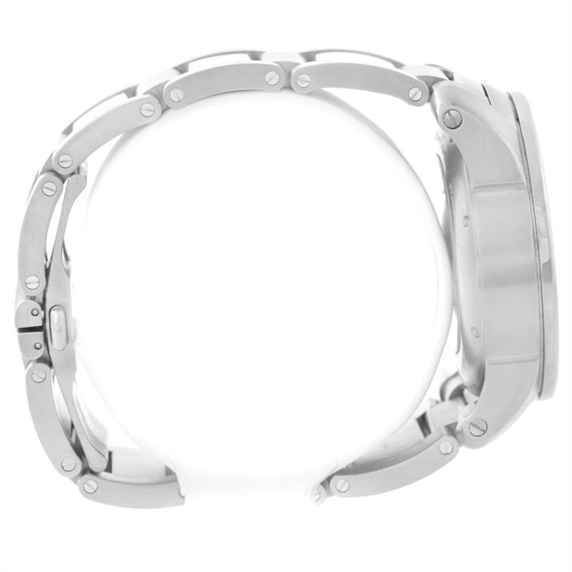 The image shows a side view of the Calibre de Cartier watch by Cartier, highlighting its metal bracelet and case edge.