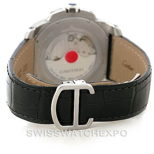 The image shows the rear view of a Calibre de Cartier watch by Cartier, highlighting the case back, leather strap, and clasp.