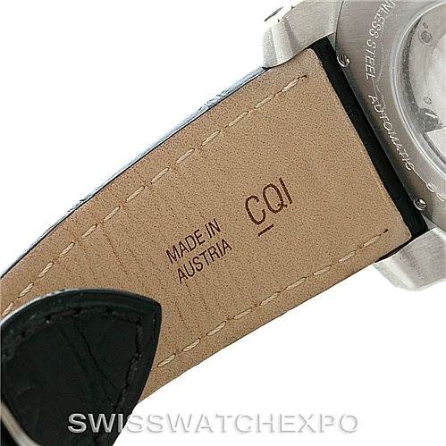 This image shows the backside of a leather strap and part of the case of a Calibre de Cartier model by Cartier.