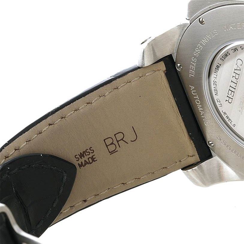 The image shows the back case and strap of the Calibre de Cartier watch by Cartier at an angled close-up.