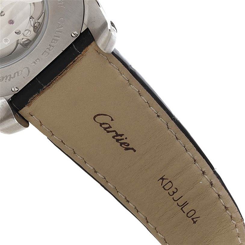 This image shows the back of the Calibre de Cartier watch by Cartier, focusing on the strap and case back.