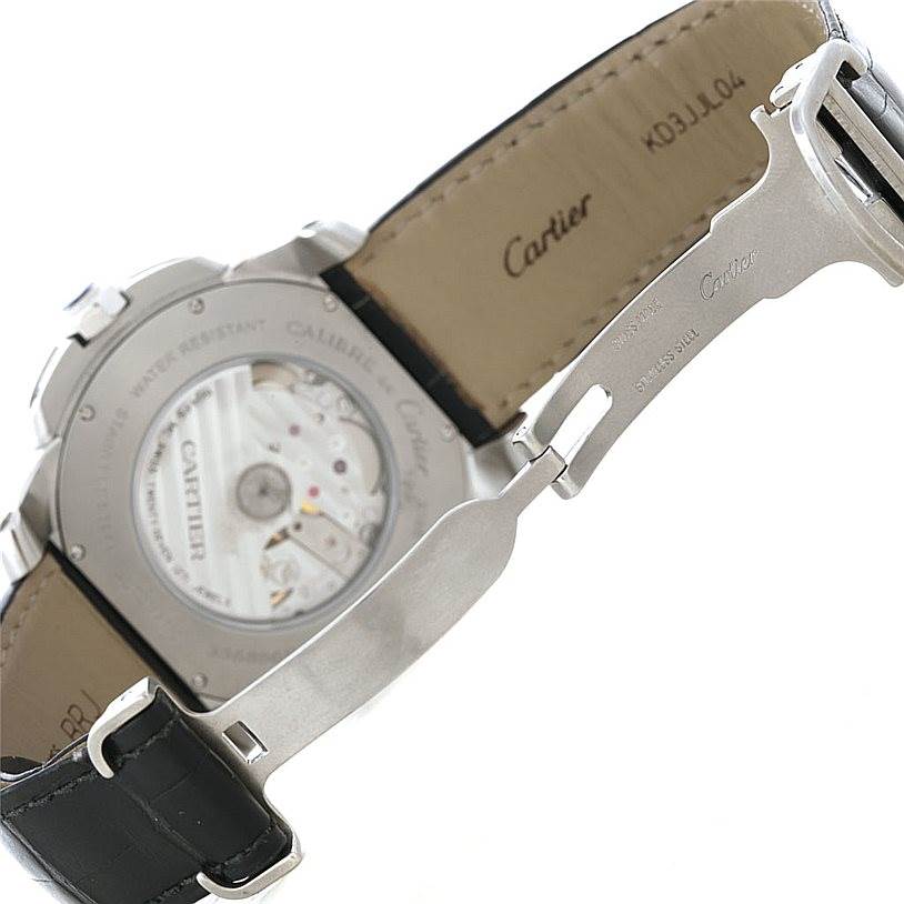 The image shows the back view of the Calibre de Cartier watch by Cartier, highlighting its movement and part of the strap.